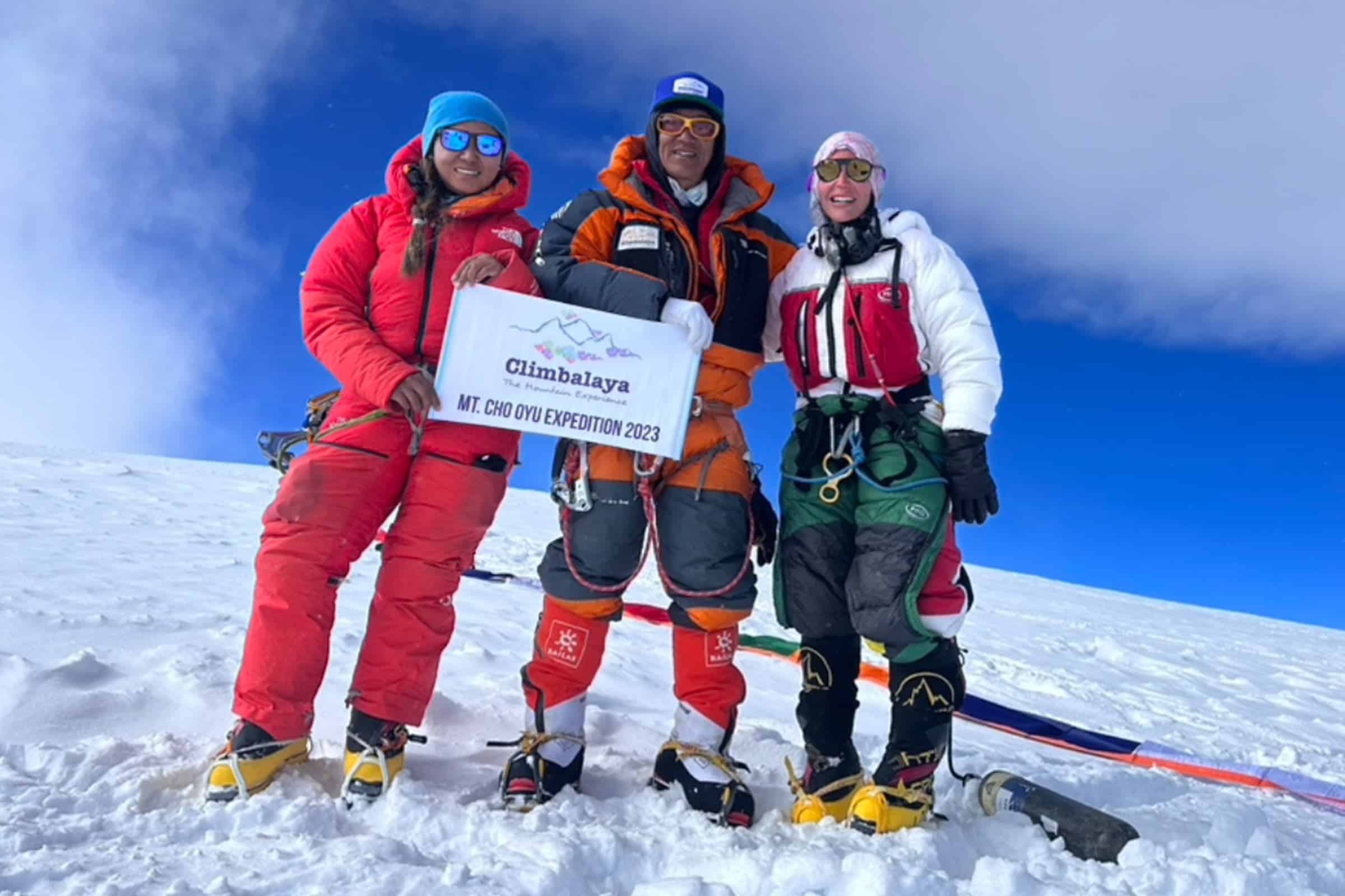 Троє альпіністів на вершині гори